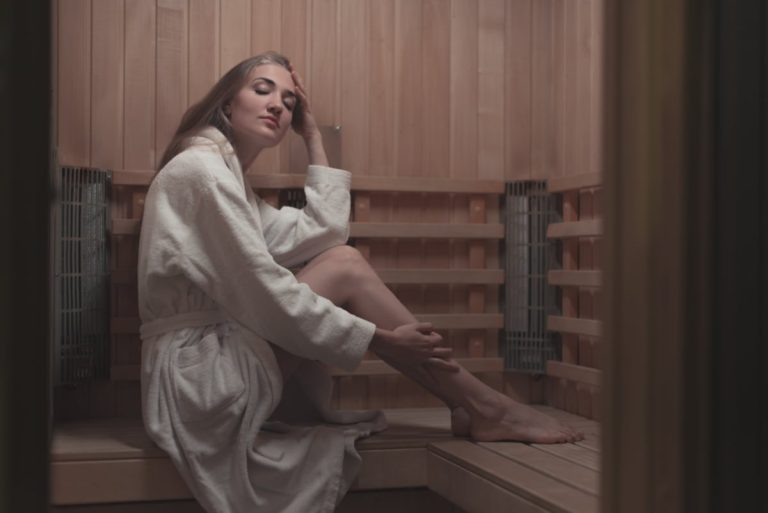young woman relaxing wooden sauna