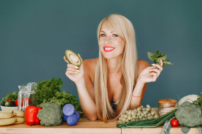 beautiful and sporty girl in a kitchen with a vegetables