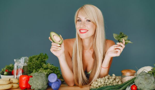 beautiful and sporty girl in a kitchen with a vegetables