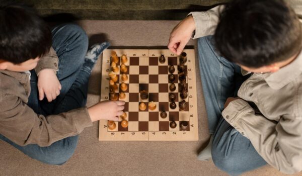 close up father boy playing chess