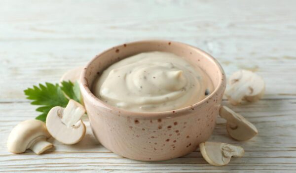 concept tasty food with mushroom sauce white wooden background