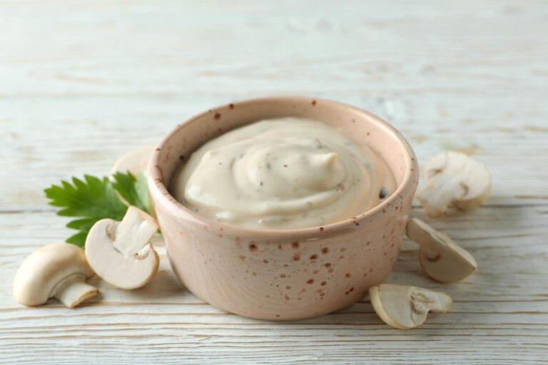 concept tasty food with mushroom sauce white wooden background