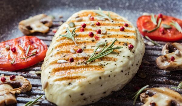 cyprus fried halloumi cheese with red tomatoes rosemary champignons close up balanced food cooking grill pan