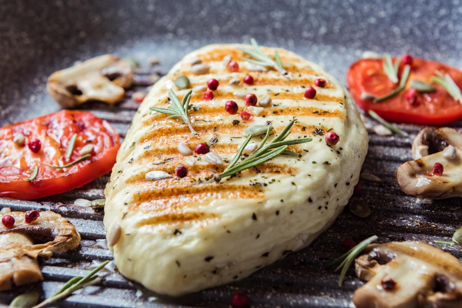 cyprus fried halloumi cheese with red tomatoes rosemary champignons close up balanced food cooking grill pan