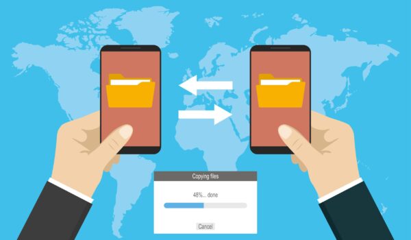 two hands holding modern smart phones and transferred documents,