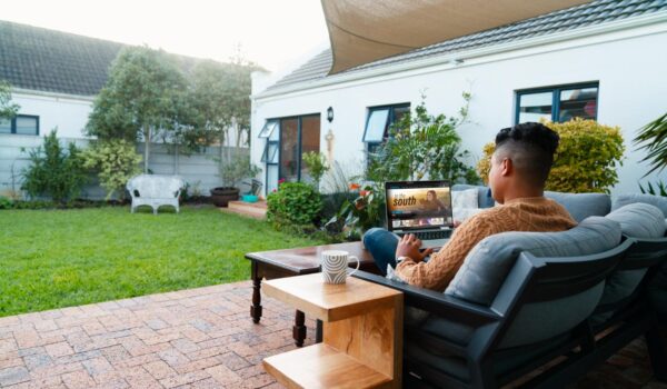 full shot man using laptop outdoors