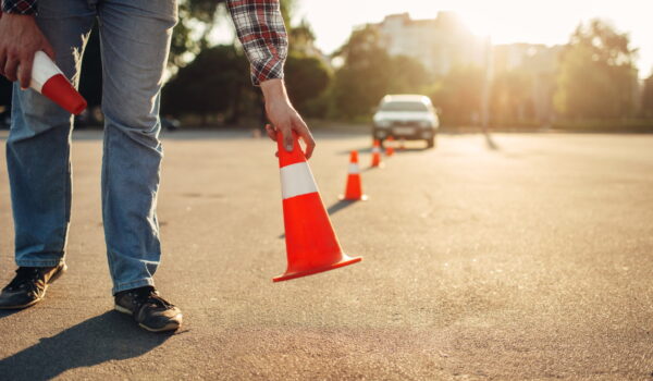 instructor sets cone driving school concept