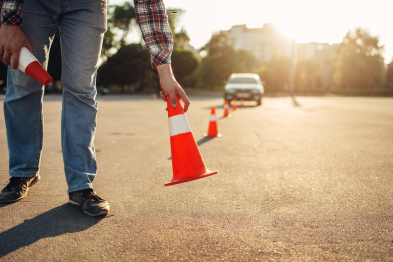 instructor sets cone driving school concept