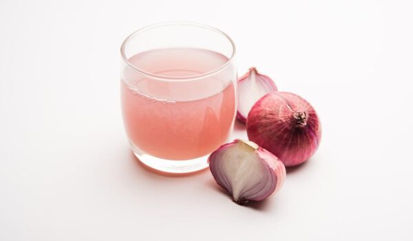 medicinal onion juice syrup glass with raw onions selective focus
