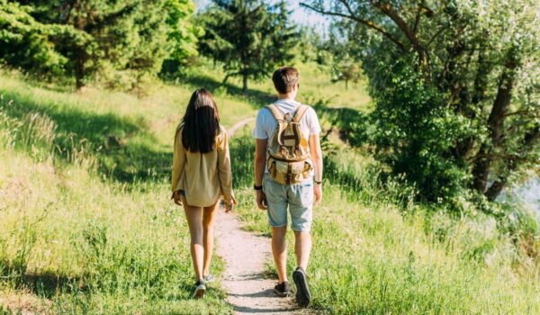 rear view couple hiking together outdoors
