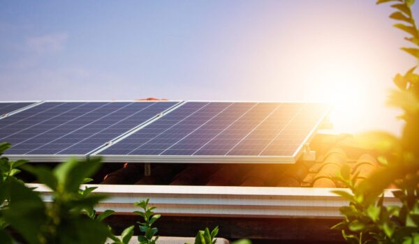 solar panels on the red roof in a sunny and cloudy day. photovol