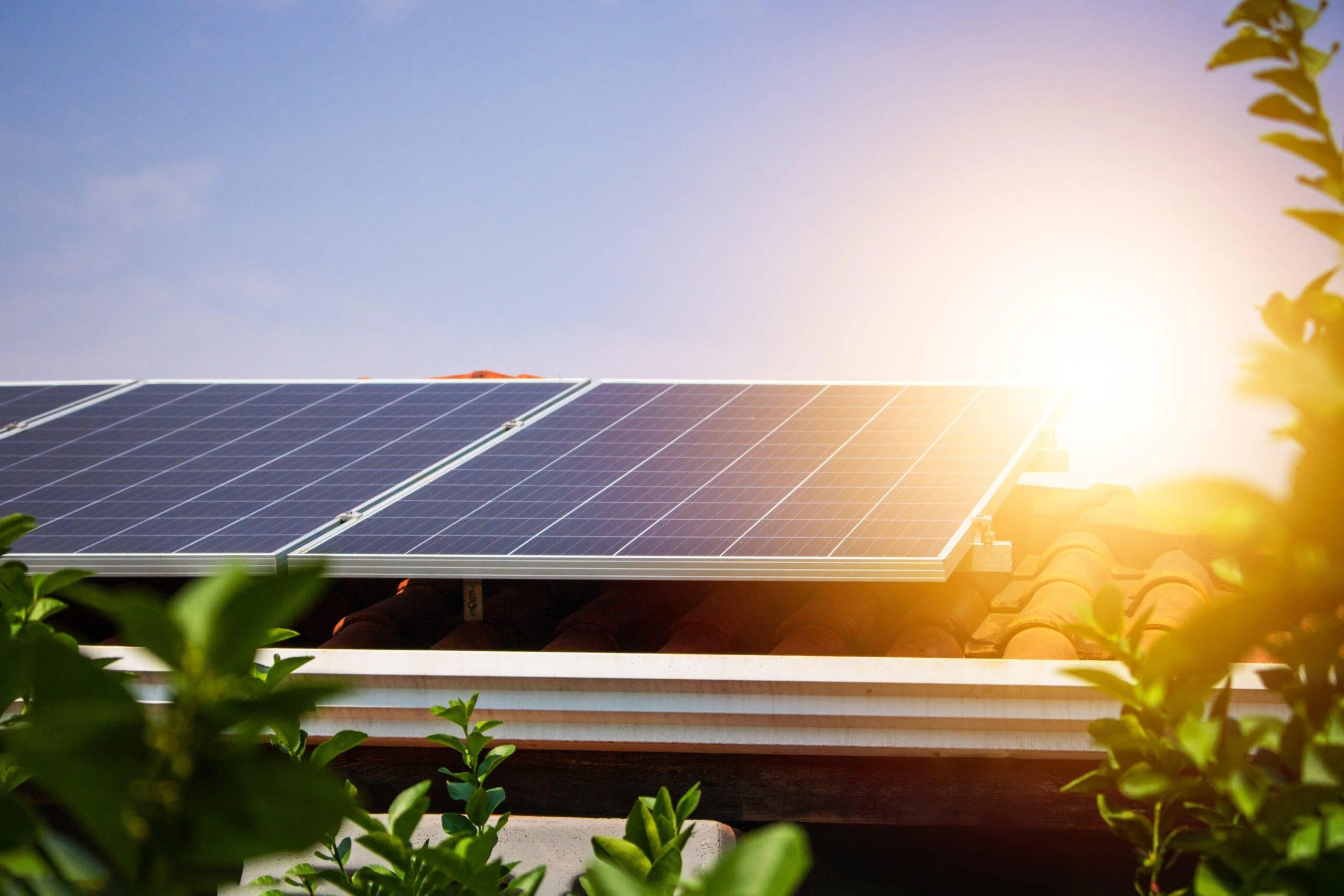 solar panels on the red roof in a sunny and cloudy day. photovol
