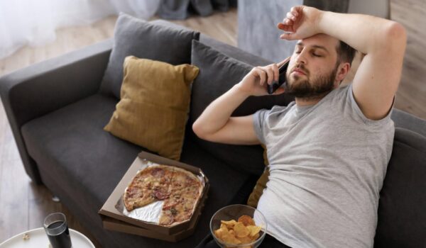 young man eating junk food home sofa
