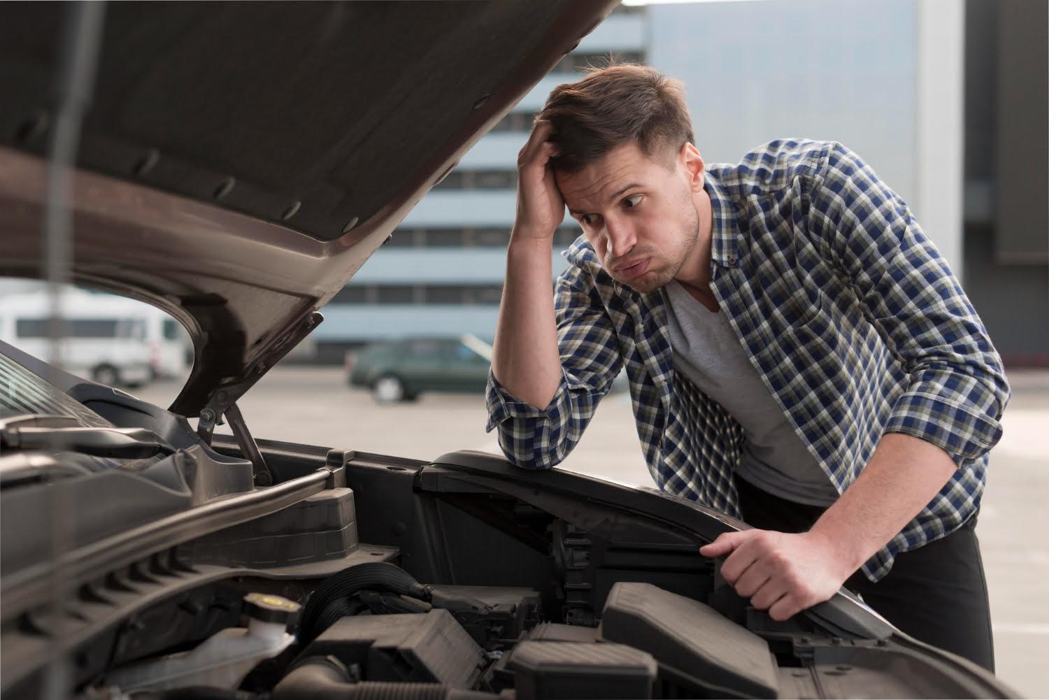 young man trying repair car